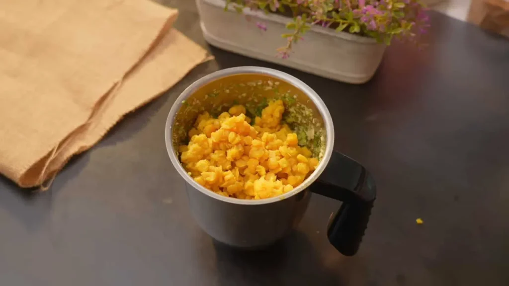 Grind boiled chana dal with spices in mixer grinder.